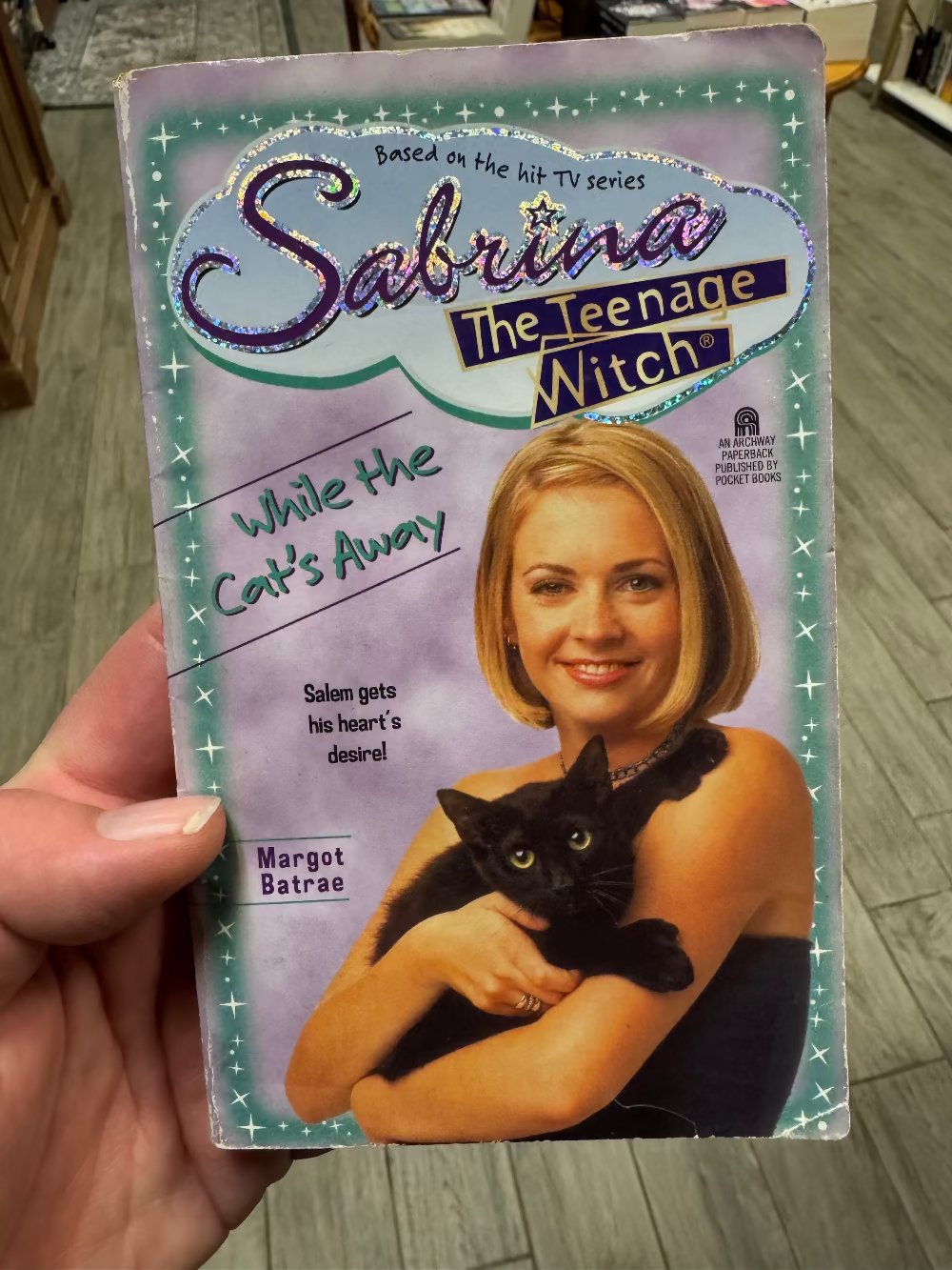 VHS tape cover of 'Sabrina the Teenage Witch' held by a hand.