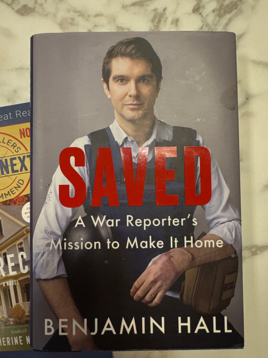 Hardcover book Saved by Benjamin Hall with red title on grey background