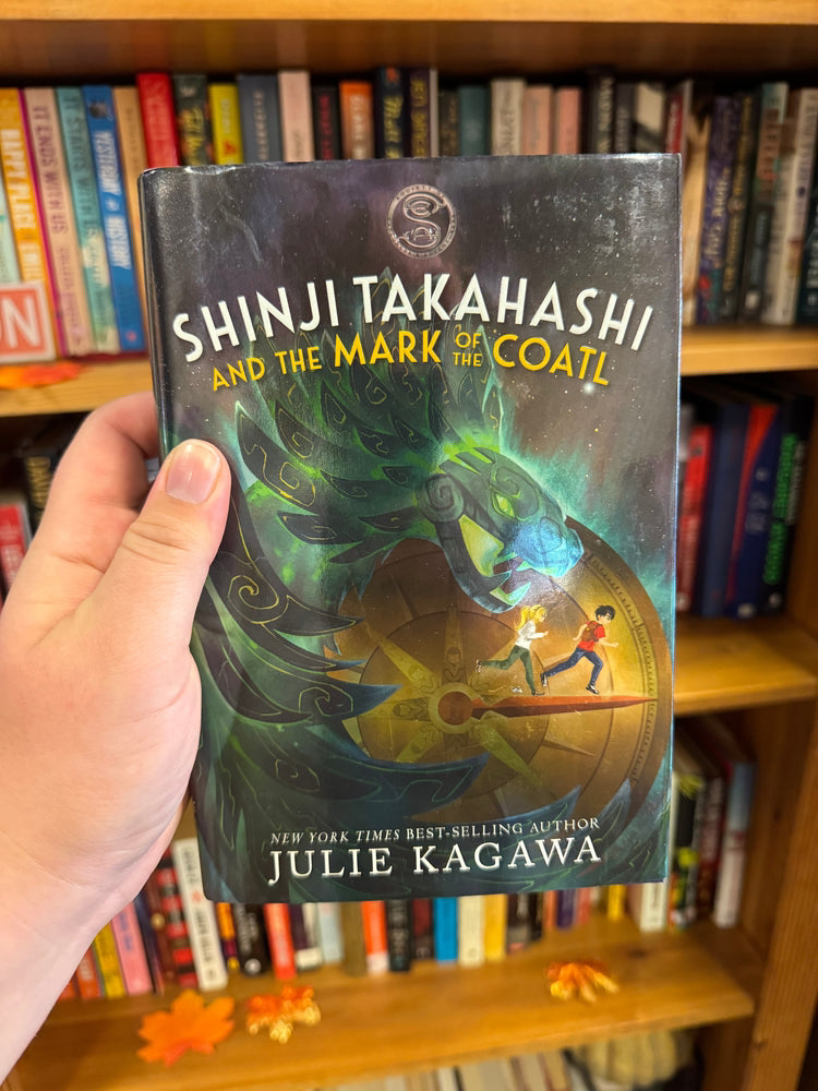 Shinji Takahashi and the Mark of the Coatl hardcover book by Julie Kagawa, dark cover with glowing green coatl serpent head illustration