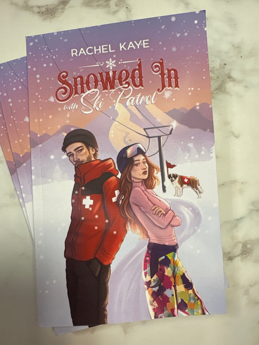 Book cover of 'Showed In' by Rachel Kaye on a marble surface