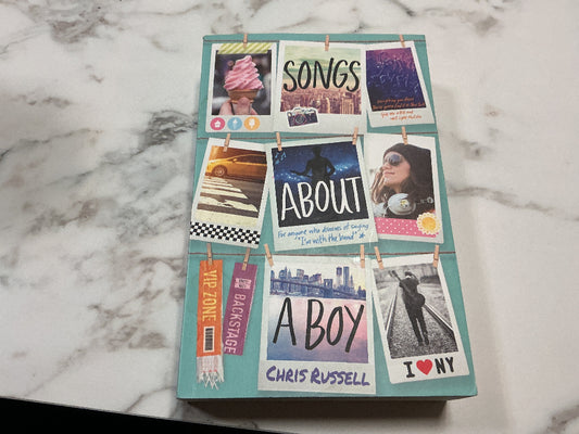 Book titled 'Songs About a Boy' by Chris Russell with photo collage on cover