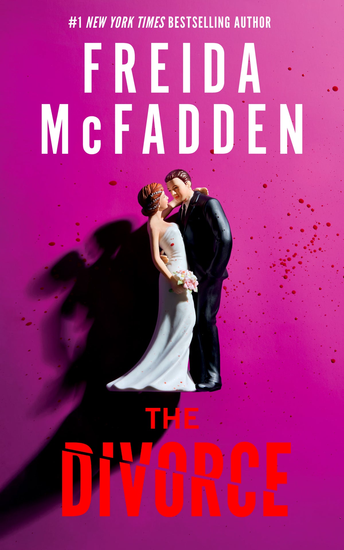 The Divorce thriller novel by Freida McFadden with magenta cover and wedding cake topper design
