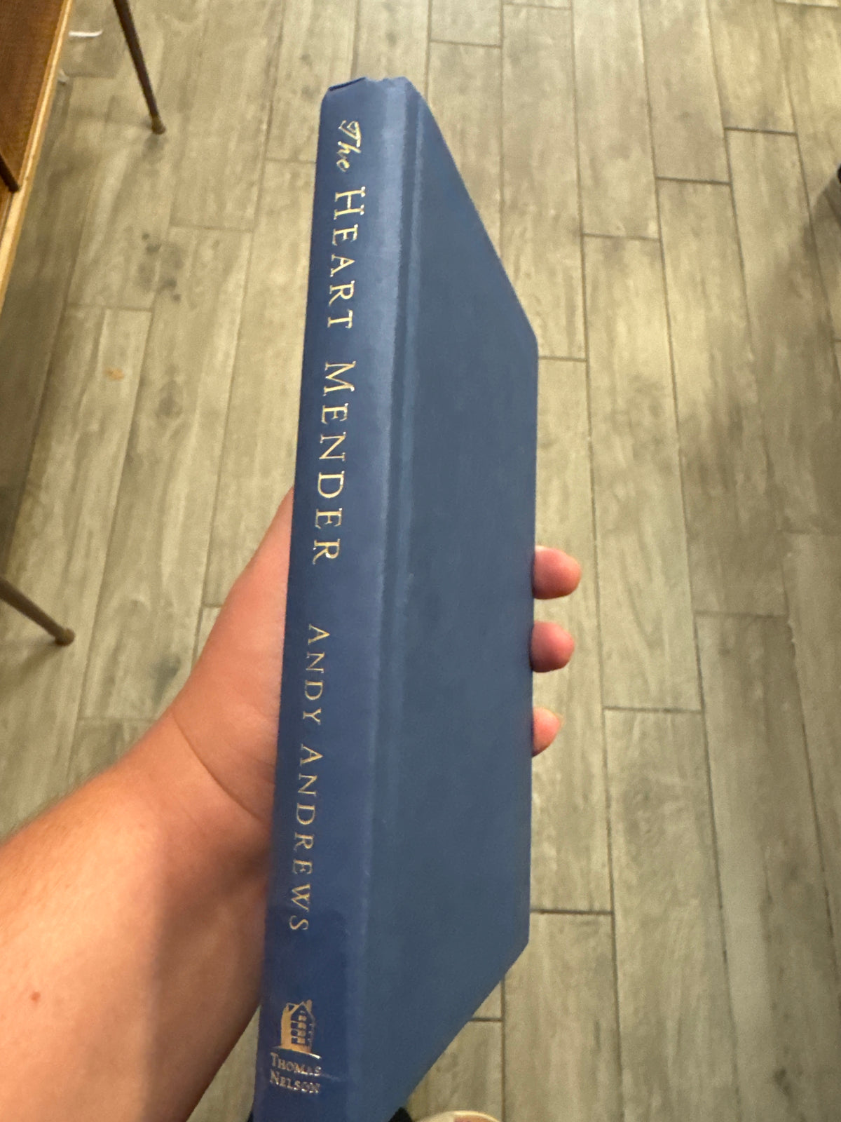 The Heart Mender hardcover book by Andy Andrews with gold spine text