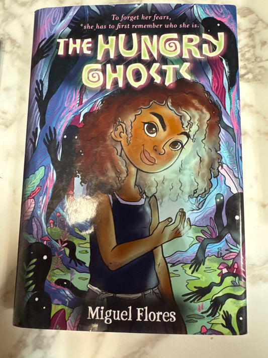 The Hungry Ghosts hardcover book by Miguel Flores with colorful forest cover art