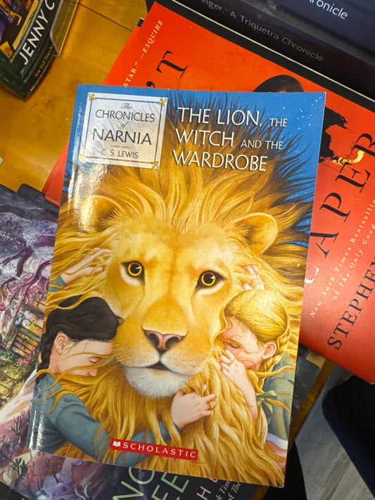 Scholastic hardcover edition of The Lion, The Witch and the Wardrobe by C.S. Lewis with golden lion cover art