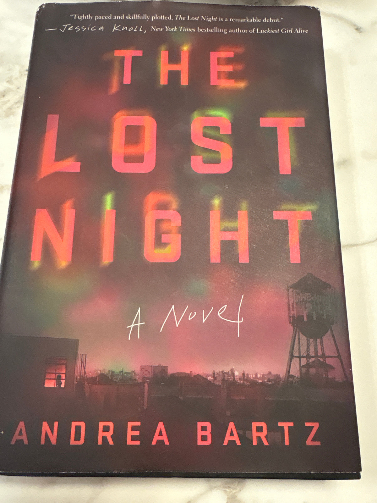 The Lost Night hardcover novel by Andrea Bartz with dark cityscape cover art