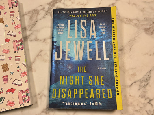 The Night She Disappeared paperback by Lisa Jewell with yellow title and bestselling author band
