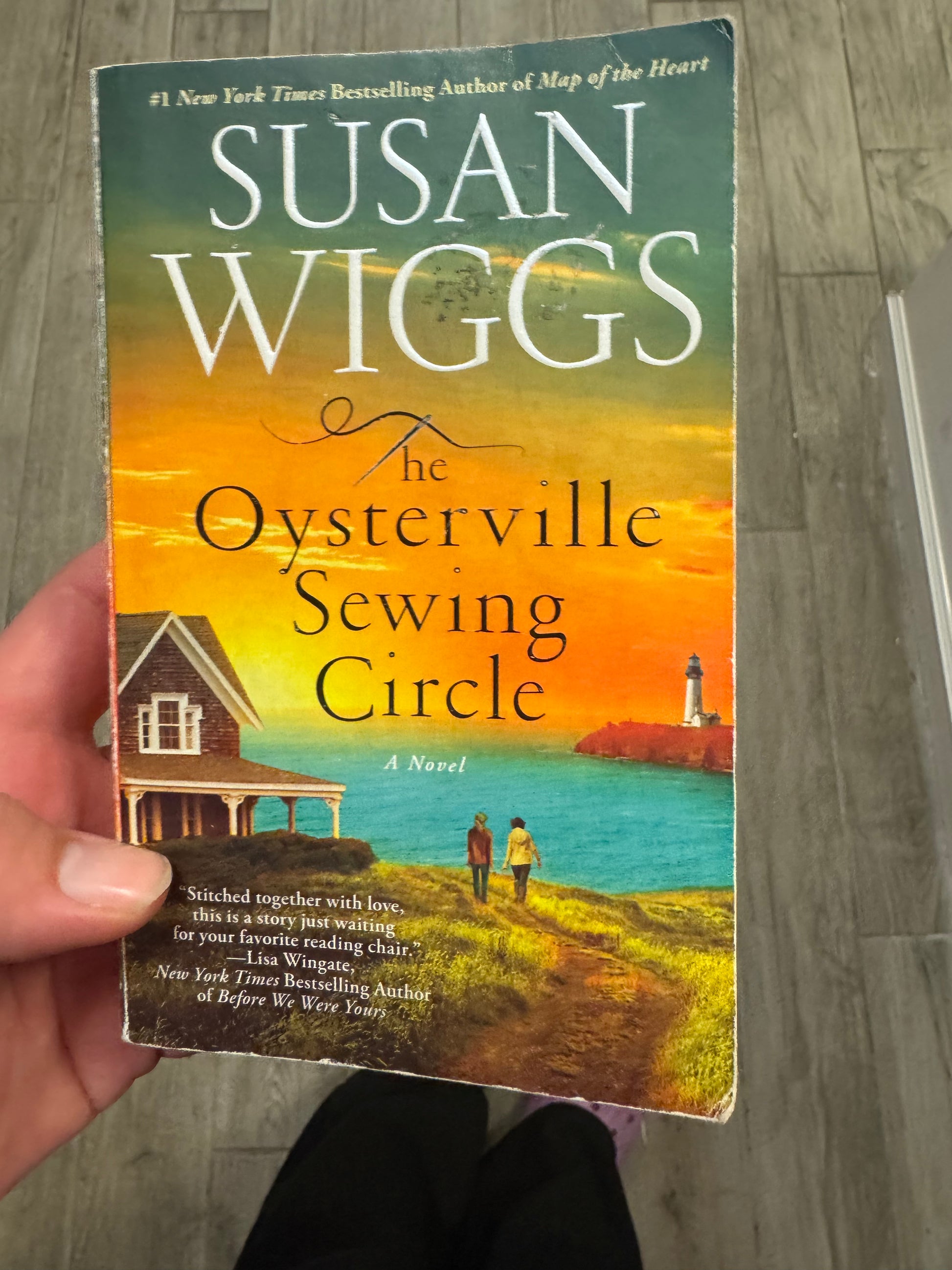 The Oysterville Sewing Circle paperback novel by Susan Wiggs with coastal sunset cover art