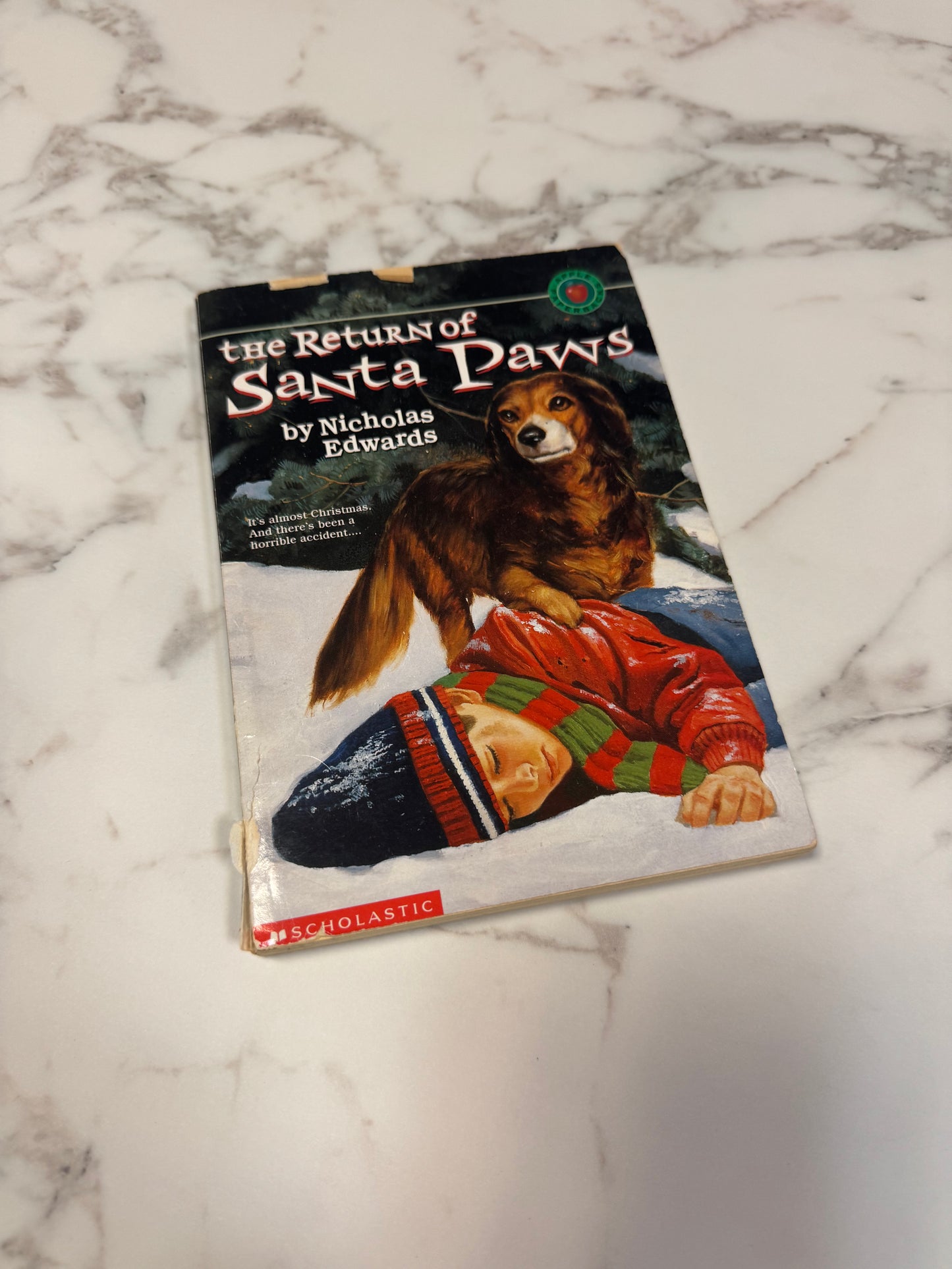 The Return of Santa Paws paperback by Nicholas Edwards with dog and child cover art
