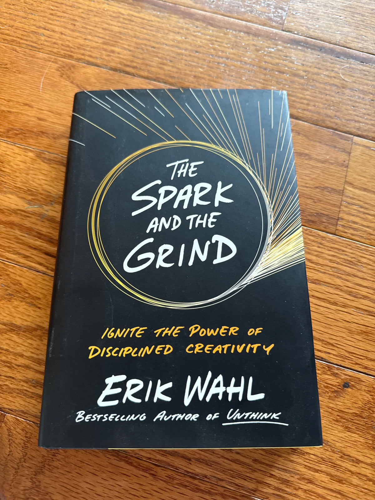 The Spark and the Grind hardcover book by Erik Wahl on wooden surface