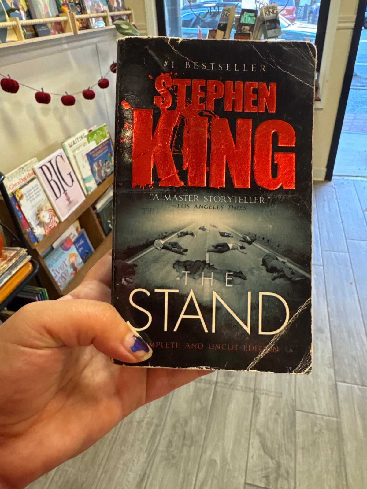 The Stand Complete and Uncut Edition paperback by Stephen King with distressed red text
