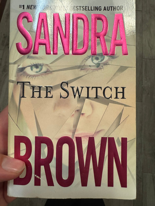 The Switch paperback by Sandra Brown with fragmented face cover design