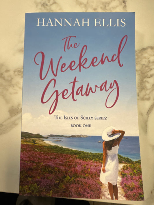 The Weekend Getaway book cover by Hannah Ellis featuring woman in white dress overlooking ocean