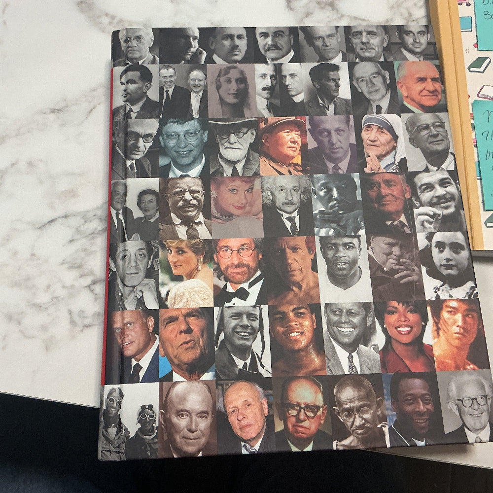 Book with collage of faces on a marble surface