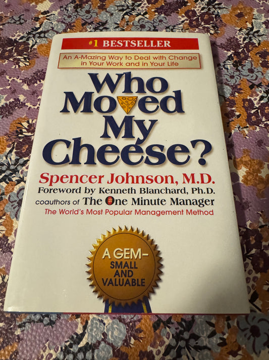 Who Moved My Cheese? hardcover book by Spencer Johnson with cheese wedge icon on white cover